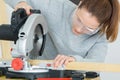 Female carpenter using circular saw Royalty Free Stock Photo