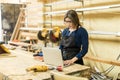 Female carpenter using a laptop