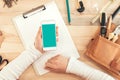 Female carpenter using smartphone, mock up screen top view