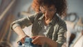 Female Carpenter Wearing Protective Safety Glasses and Using Electric Belt Sander to Work on a Wood Royalty Free Stock Photo