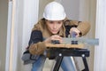 Female carpenter at work on saw bench