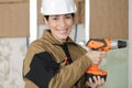 female carpenter at work using hand drilling machine Royalty Free Stock Photo