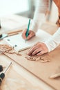 Female carpenter working with wooden dowels