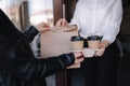 Female cashier in face mask serving coffee and package with food to customer. Coffee shop open after lockdown. Woman Royalty Free Stock Photo