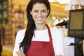 Female Cashier At Supermarket Checkout Royalty Free Stock Photo