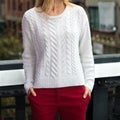 Female casual spring autumn outfit white knitted sweater and red cotton pants outdoors