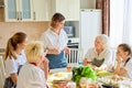 Caucasian woman in casual wear have talk while other members of family drink tea Royalty Free Stock Photo