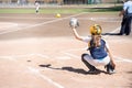 A female catcher crouching alone receiving the ball from the pitcher in a baseball game on the Turia River in Valencia Royalty Free Stock Photo