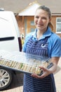 Female Caterer Delivering Tray Of Sandwiches To House