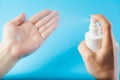 Female caucasian hands spraying antibacterial alcohol sanitizer