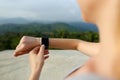 Female caucasian hands using smart watch, mountains in background. Royalty Free Stock Photo