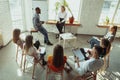 Female caucasian speaker giving presentation in hall at university or business centre workshop Royalty Free Stock Photo