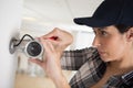 female cctv installer checking security camera Royalty Free Stock Photo