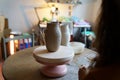 Female ceramist look at potter jug after master class in studio. Woman in workshop practice ceramics