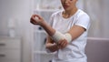 Female checking arm with elbow elastic warp after sport trauma orthopedics