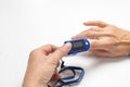 Female is checking data on a compact electronic pulse oximeter