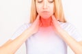 Female checking thyroid gland by herself. Close up of woman in white t- shirt touching neck with red spot. Thyroid