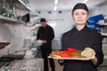 Female chef with cooked dish Royalty Free Stock Photo