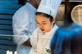 A female chef cooking food at the restaurant in Yu GardenÃ¯Â¼ËYuyuan, a top tourist spot in shanghai china