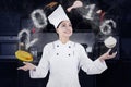 Female Chef Cooking Like A Juggler Royalty Free Stock Photo