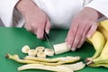 Female chef cutting a banana Royalty Free Stock Photo