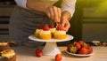 Female chef decorating cakes with fruits on the table