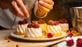 Female chef decorating cakes with fruits on the table