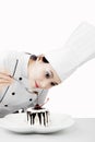 Female chef decorating a tasty cake Royalty Free Stock Photo