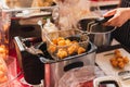 Female chef deep fried meat ball in kitchen. Royalty Free Stock Photo