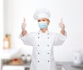 Female chef in face mask showing thumbs up