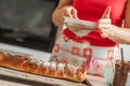 Female chef finishing sweet cake with sugar on the top Royalty Free Stock Photo