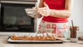 Female chef finishing sweet cake with sugar on the top Royalty Free Stock Photo