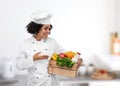 female chef with food in wooden box in kitchen Royalty Free Stock Photo