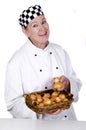 Female chef holding a basket with onions