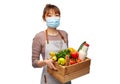 female chef in mask with food in wooden box Royalty Free Stock Photo