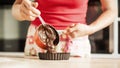 Female chef melted chocolate and preparing sweet cake for dessert Royalty Free Stock Photo