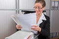 Female chef in the office with a lot of papers Royalty Free Stock Photo