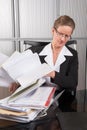 Female chef in the office with a lot of papers Royalty Free Stock Photo