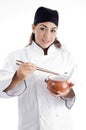Female chef posing with chopstick and bowl Royalty Free Stock Photo