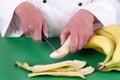 Female chef preparing a banana Royalty Free Stock Photo