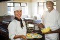 Female chef presenting dessert plates Royalty Free Stock Photo