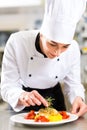 Female Chef in restaurant kitchen cooking Royalty Free Stock Photo