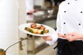 Female Chef in restaurant kitchen cooking Royalty Free Stock Photo