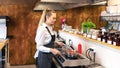 Female chef in restaurant or new small business kitchen cooking delicious food on modern electric stove Royalty Free Stock Photo