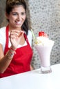 Female chef serving strawberry shake