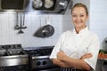 Portrait Of Female Chef Standing In Kitchen Royalty Free Stock Photo