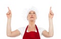 Female chef in uniform pointing upwards Royalty Free Stock Photo