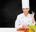 Female chef with vegetables showing ok sign Royalty Free Stock Photo