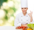 Female chef with vegetables showing ok sign Royalty Free Stock Photo