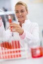 Female chemical technician full test tube with sample liquid